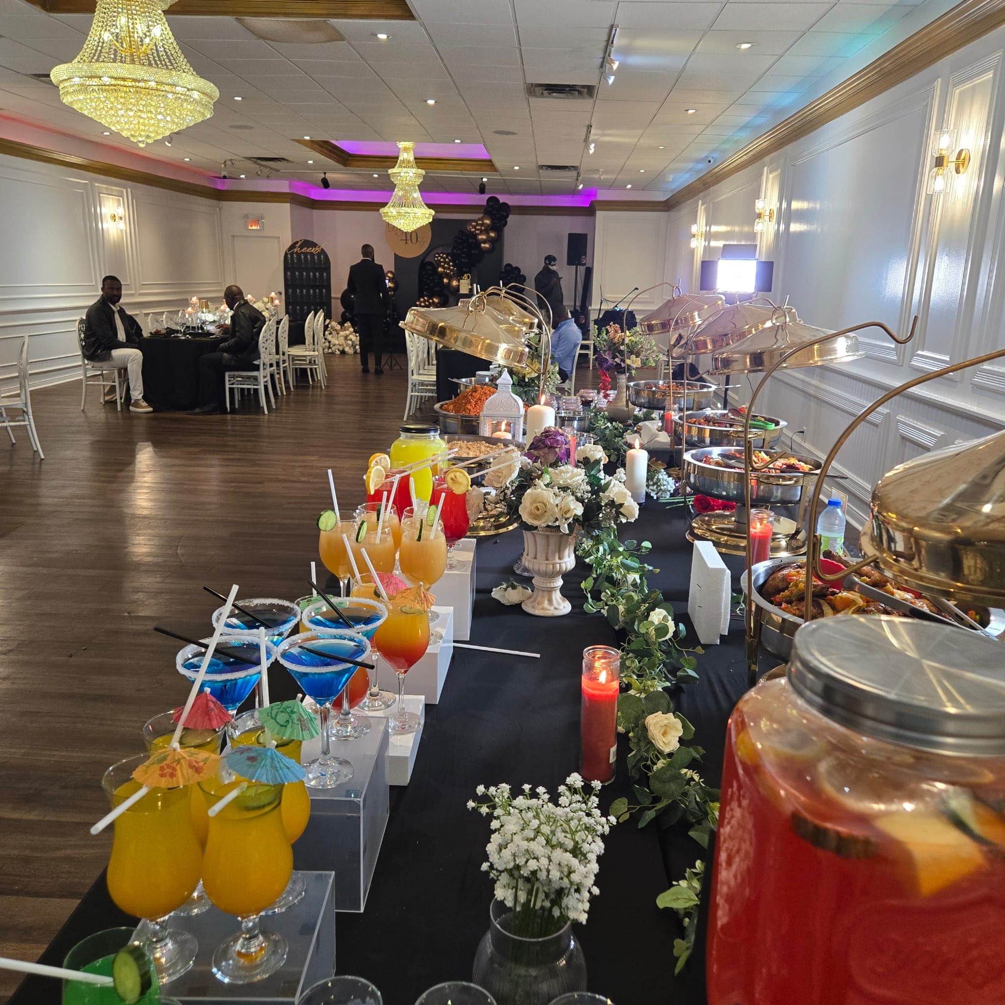 Live event at the banquet hall with a colourful cocktail and food display on a long table.