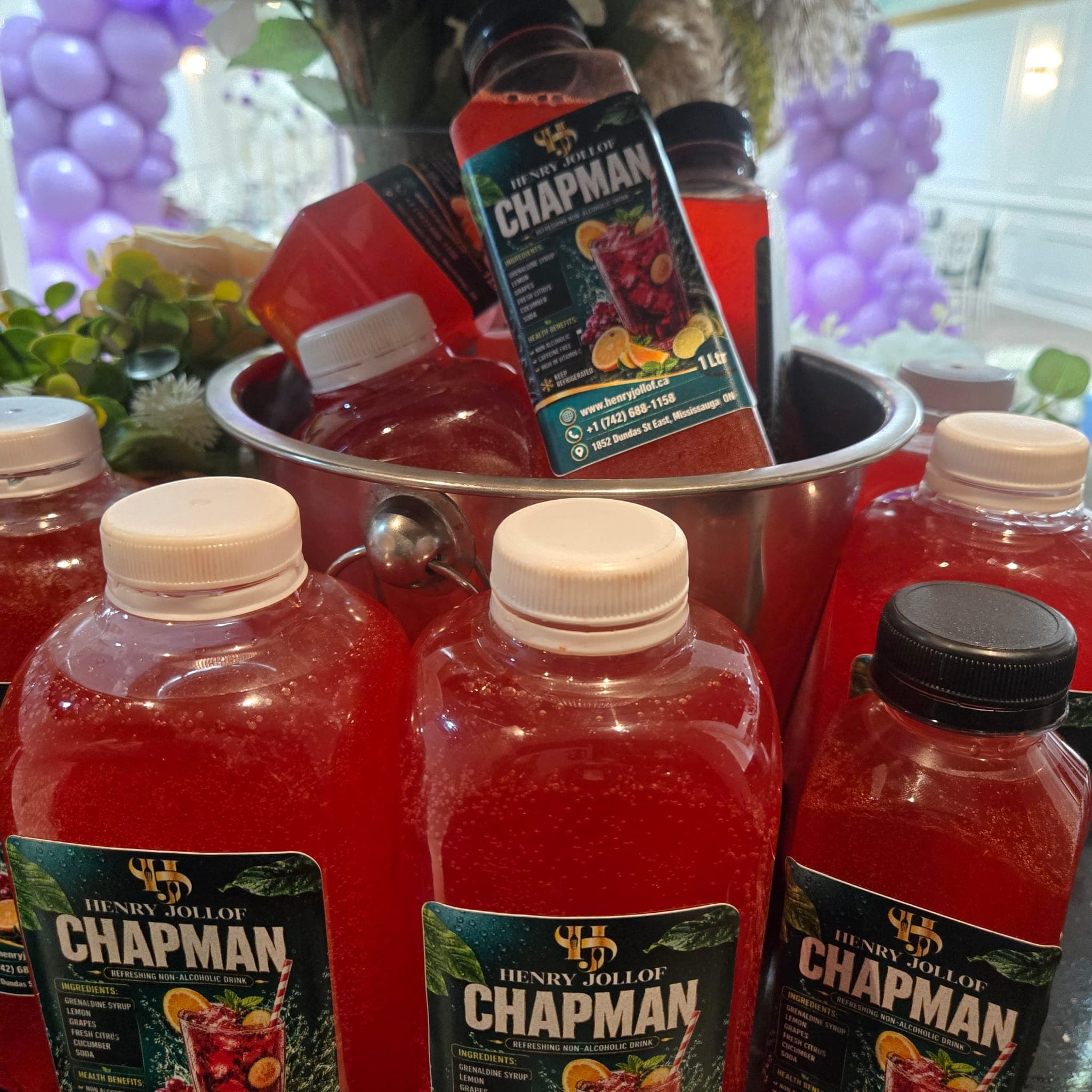 Bottles of Henry Jollof Chapman, a refreshing non-alcoholic drink, chilling on ice.
