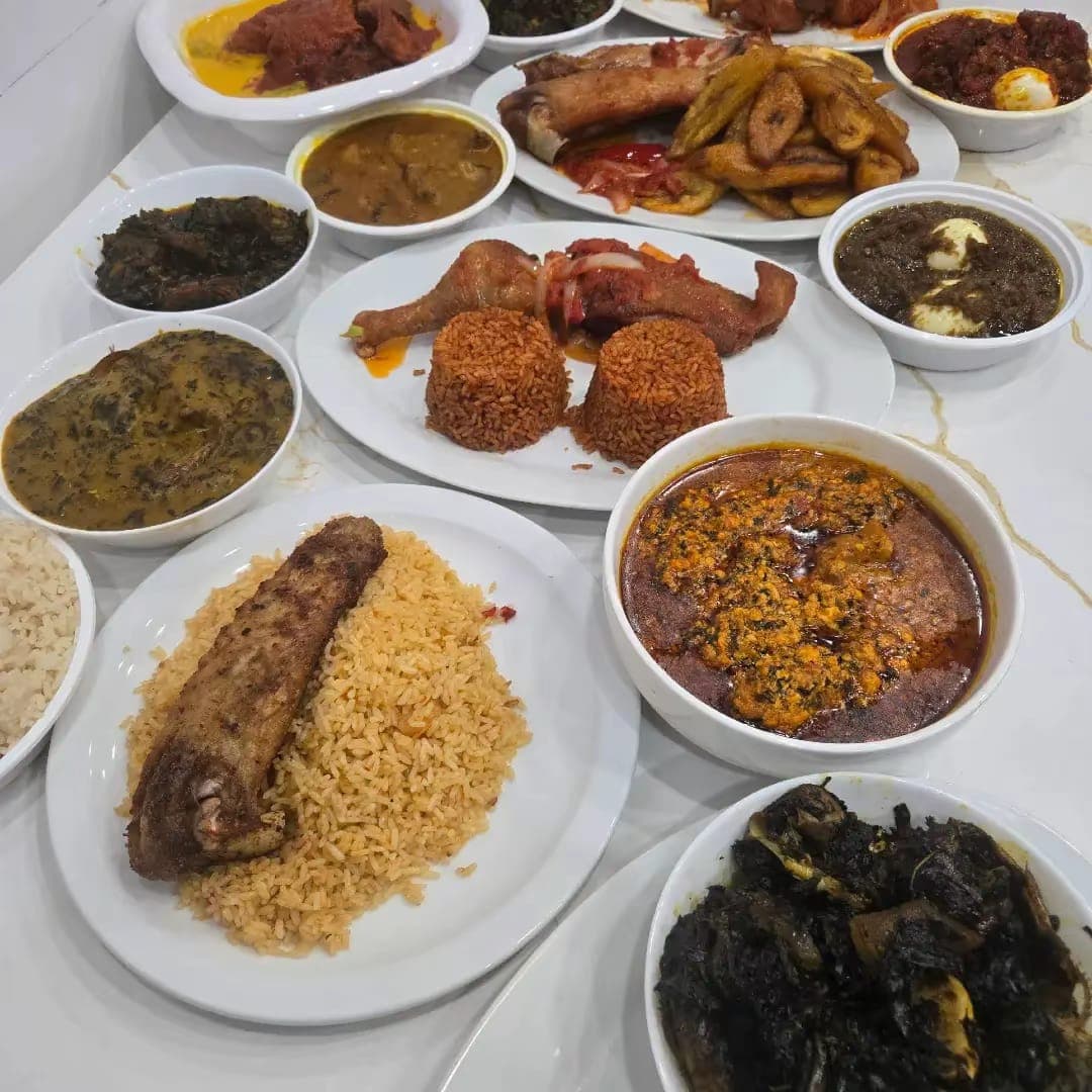 Fried rice tray served alongside Nigerian soups and grilled chicken.