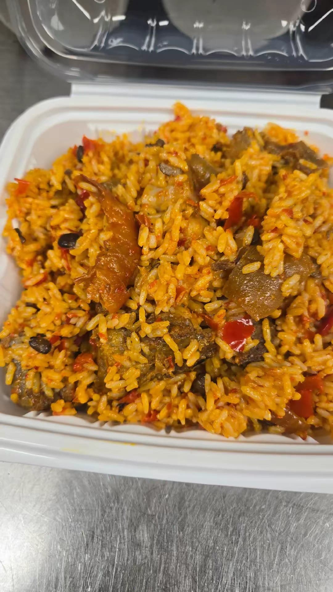 Native palm oil rice with assorted meat, dried fish and peppers.