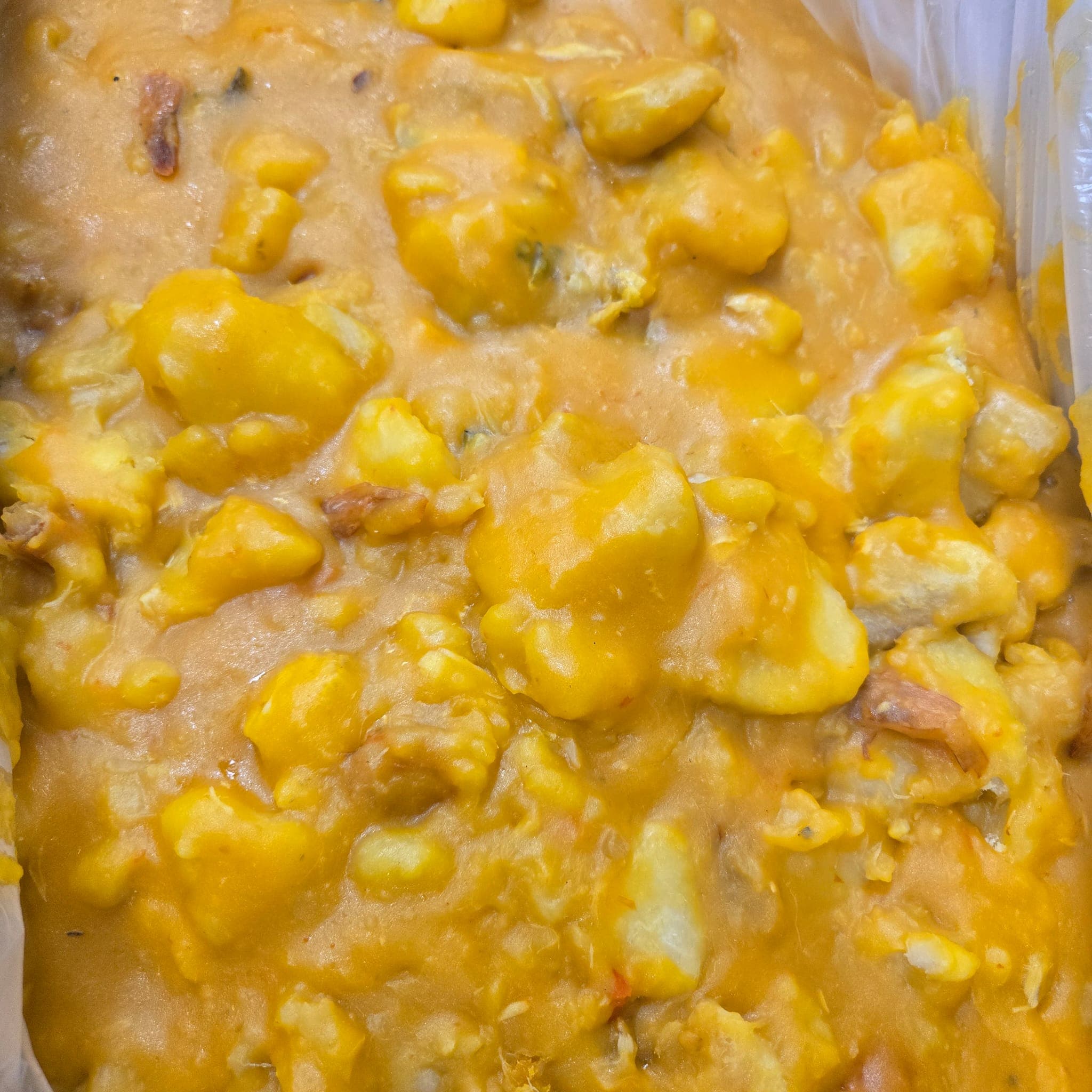 Yam porridge (asaro) cooked soft in palm oil with fish and peppers.